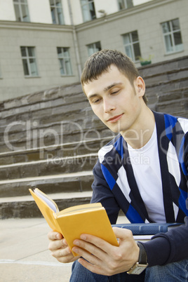 Male student on campus with textbooks