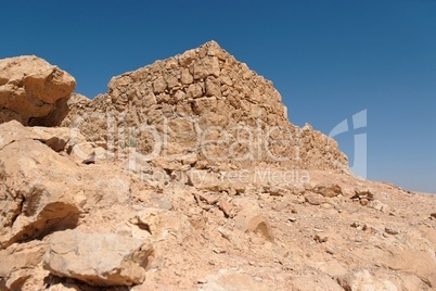 Ruins of ancient stone tower on desert hill