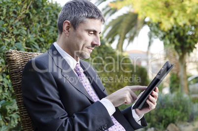 Business Man Working Outdoor with his Tablet