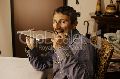 Man Working in his House Badly Reacting against  a Modern Laptop