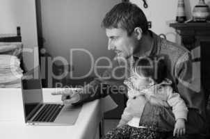 Man Teaching his Daughter Using Laptop