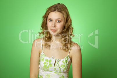 Beautiful young woman on green background