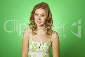 Beautiful young woman on green background