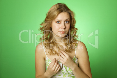 Beautiful young woman on green background