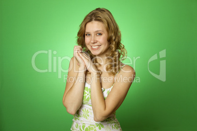 Beautiful young woman on green background