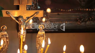 Crucifix and burning candles
