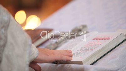 priest reading Bible