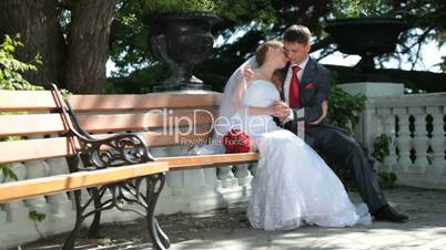 bride and groom on the bench