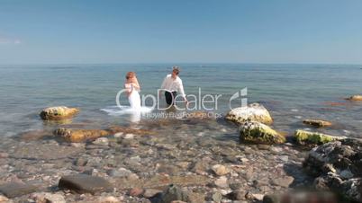 bride and groom splashes in the water