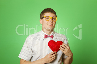 Smiling guy holding heart shape