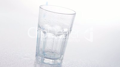 Blue liquid pouring into glass