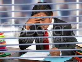 Businessman Reading Documents At His Desk