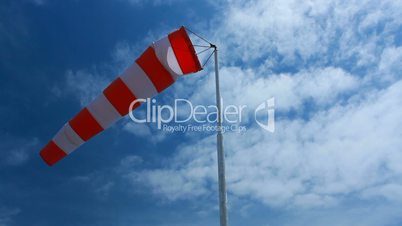 wind sock & blue sky with fluffy clouds