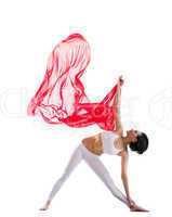 woman exercise yoga asana and red flying fabric