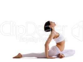 Yong woman sit in yoga asana - pigeon pose