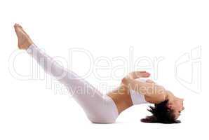 Young woman training yoga - fish pose in white