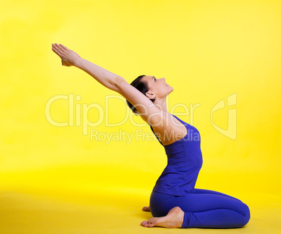 Yong woman doing yoga asana - pigeon pose