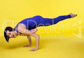 woman doing arm balance yoga and fall