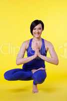 woman smile in yoga pose - blue on yellow