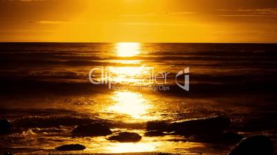 Sunset timelapse with waves crash on shore