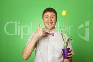 Man holding a tulip grown in a pot