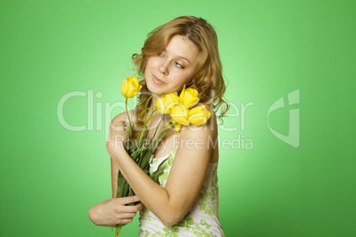 Happy Young Woman hugging a bouquet of tulips