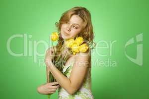 Happy Young Woman hugging a bouquet of tulips