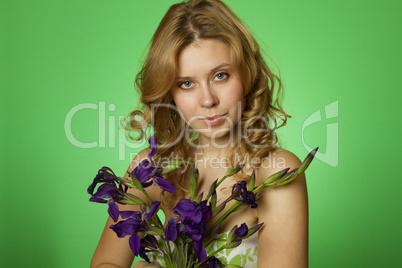 Attractive girl hugging a bouquet of iris