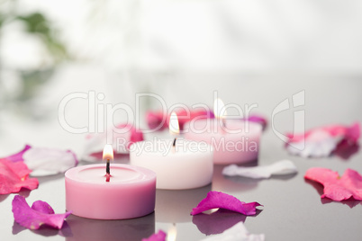 Lighted candles and petals