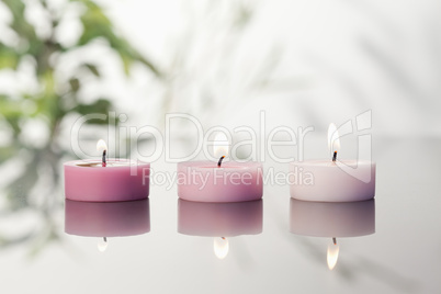 Lighted candles on a mirror