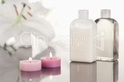 White orchid  glass phials and pink lighted candles