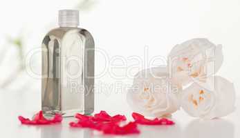 Glass flask with petals and roses