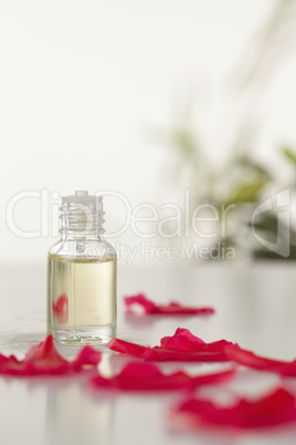 Glass phial and pink petals