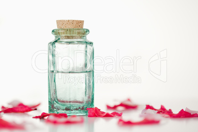 Pink petals and glass flask