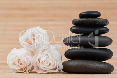 Close up roses and a black pebbles stack