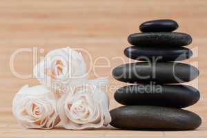 Close up roses and a black pebbles stack