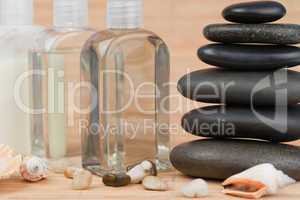 Close up of pebbles with a black pebbles stack and glass flasks