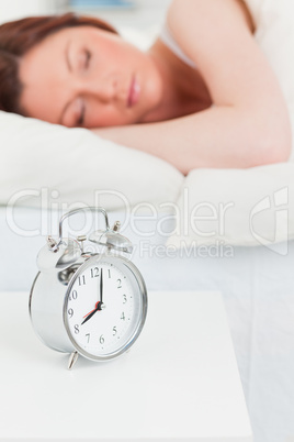 Attractive red-haired woman sleeping in her bed