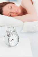 Attractive red-haired woman sleeping in her bed