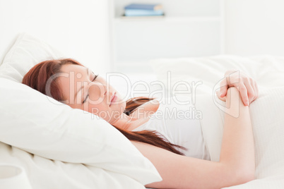 Close-up of a pretty red-haired female sleeping in her bed Close-up of a pretty red-haired female sleeping in her bed