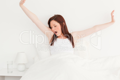 Pretty red-haired female stretching in her bed Pretty red-haired female stretching in her bed