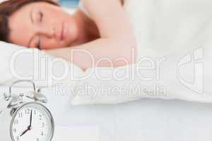 Beautiful red-haired female sleeping in her bed