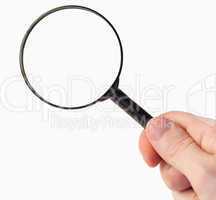 Hand holding a magnifying glass