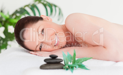 Happy young woman lying on her belly