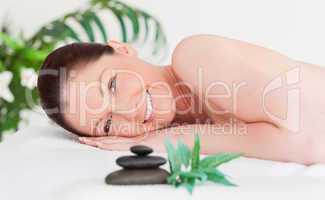 Happy young woman lying on her belly