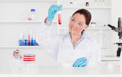 Young scientist looking at a test tube