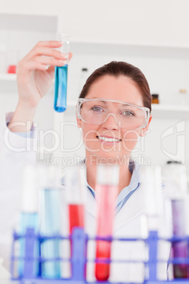 Young scientist looking at test tubes with the camera focus on t