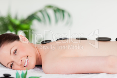 Smiling beautiful woman having a stone massage