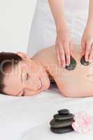 Yound redhead female having a hot stone massage