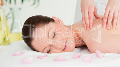 Cute woman receiving a massage in a spa